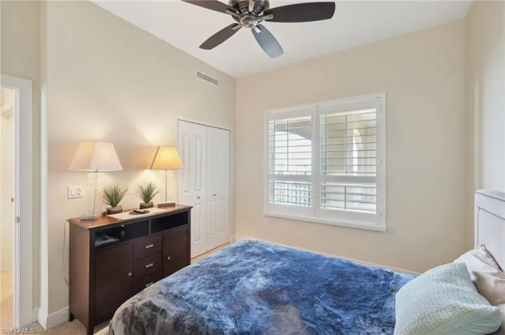 Bedroom with baseboards, visible vents, a closet, and ceiling fan