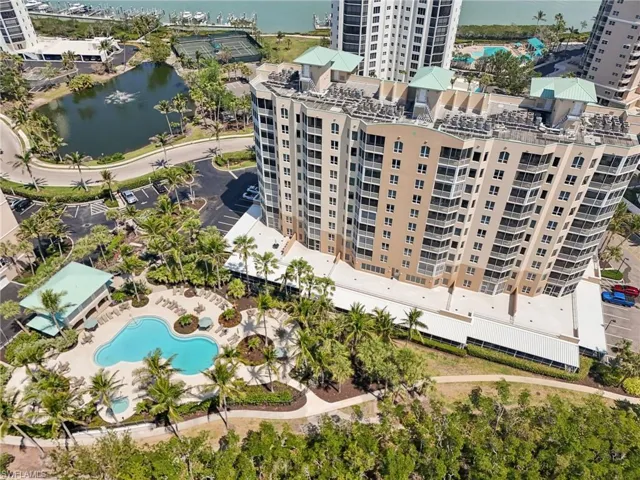 Birds eye view of property with a water view and a view of city