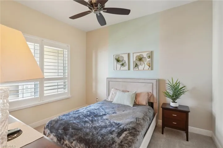 Bedroom featuring carpet flooring, a ceiling fan, and baseboards