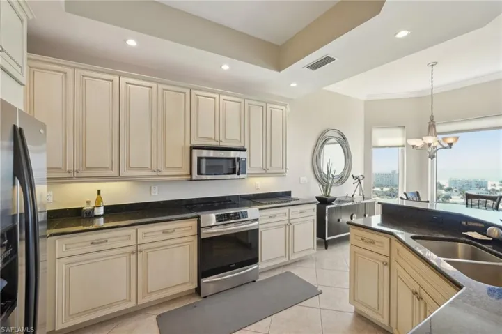 Kitchen featuring a sink, visible vents, cream cabinets, and appliances with stainless steel finishes