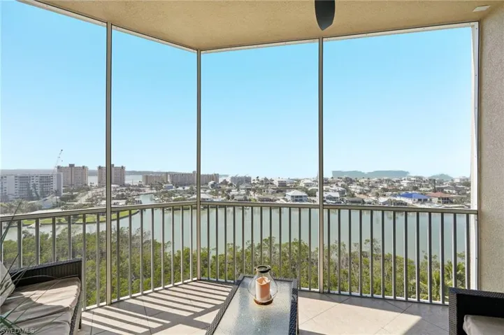 Unfurnished sunroom with a water view and a view of city