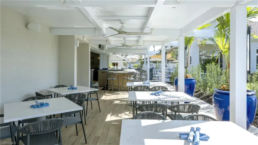 Sunroom featuring outdoor dining space, a ceiling fan, beamed ceiling, a deck, and coffered ceiling