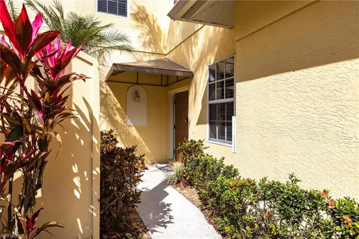 Doorway to property featuring stucco siding