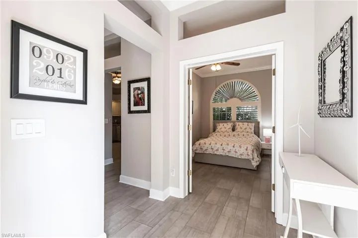 Hallway featuring crown molding and light wood-type flooring