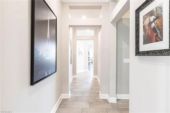 Hall with baseboards and light wood-style flooring