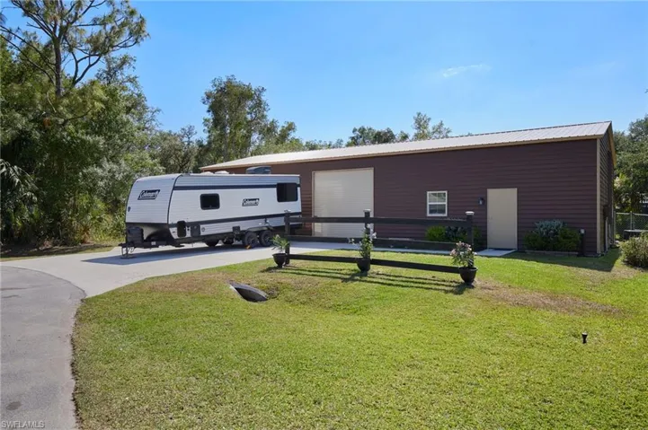Detached 1800 SqFt Garage with two 10' roll up doors, dedicated offices, and workshop.