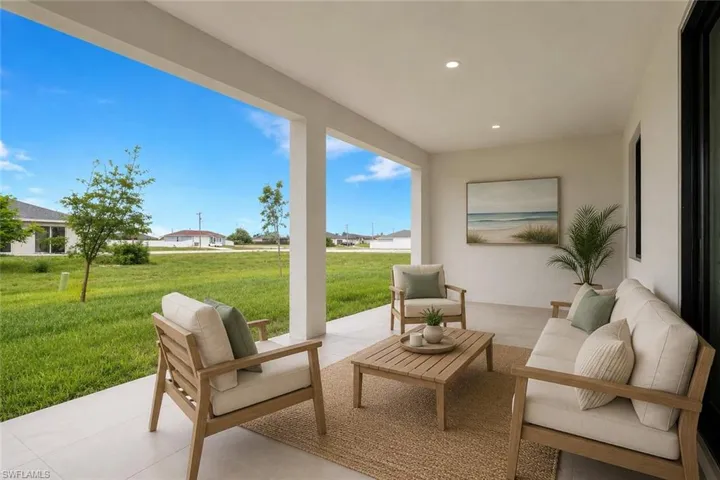 Spacious covered patio with light-toned flooring and recessed lighting