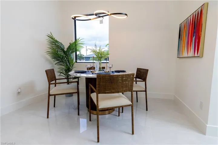 Dining space with light tile patterned flooring