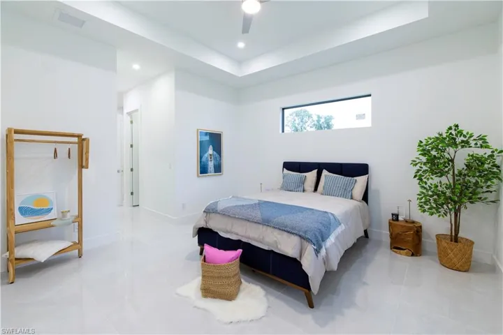 Bedroom featuring light tile patterned floors and ceiling fan