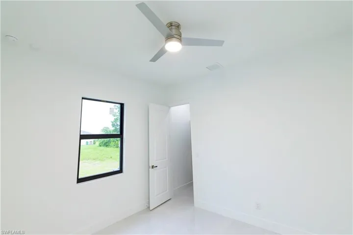 Unfurnished room featuring ceiling fan