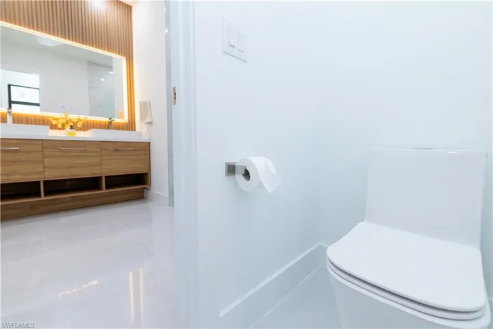 Bathroom with vanity, tile patterned flooring, and toilet