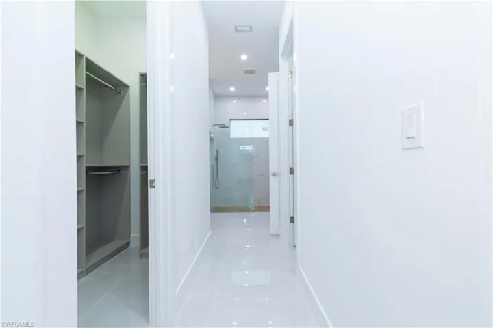 Hall featuring light tile patterned floors