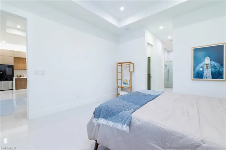 Bedroom with stainless steel refrigerator and ensuite bath