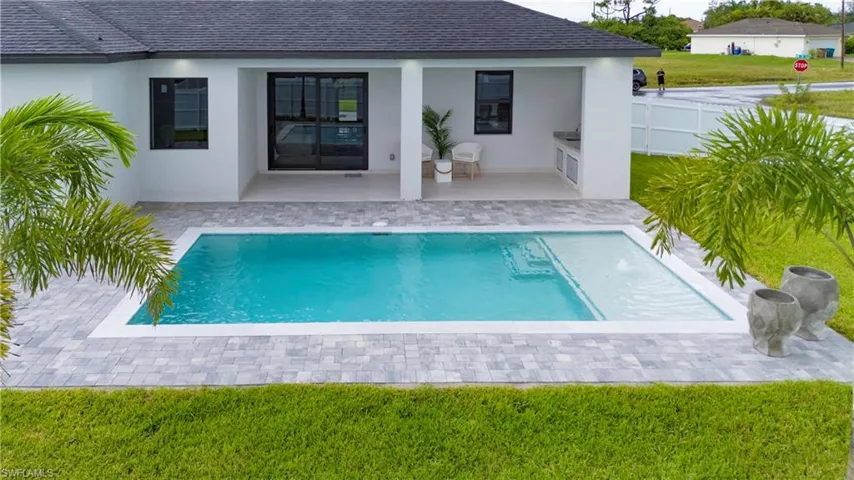 View of swimming pool featuring a lawn and a patio