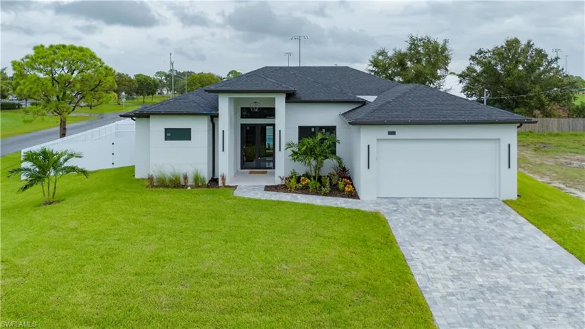 View of front of home with a garage and a front yard
