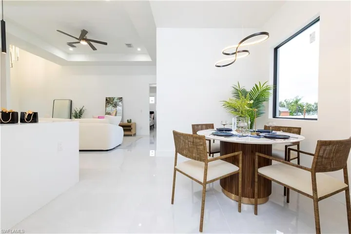 Dining room with a tray ceiling and ceiling fan