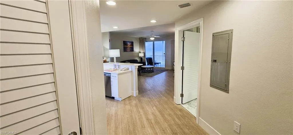 Hallway featuring light wood-type flooring and electric panel