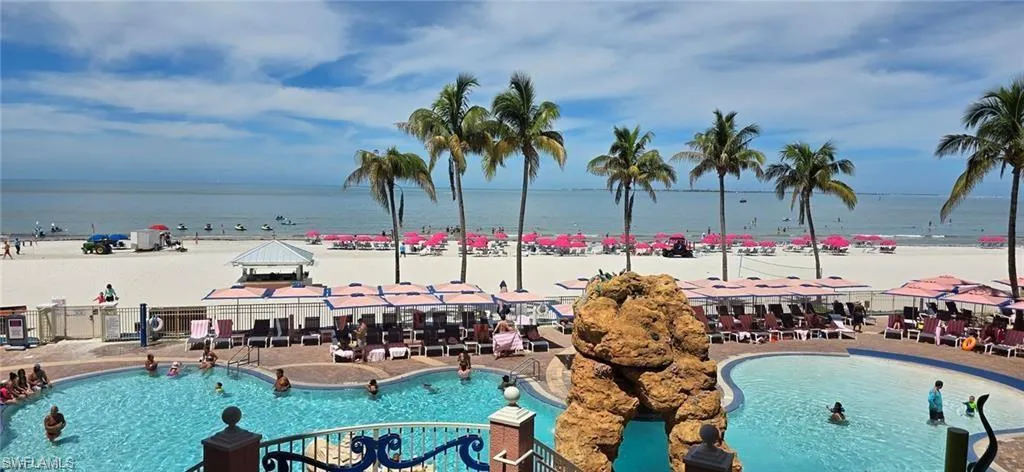 View of pool with a water view and a gazebo