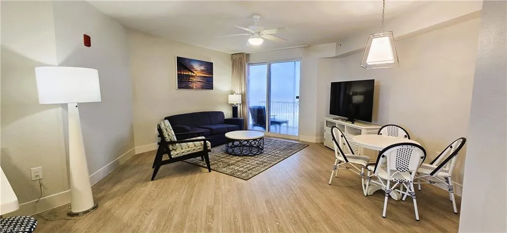 Living room featuring light hardwood / wood-style flooring and ceiling fan