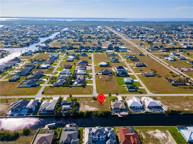 Aerial view featuring a water view and a residential view