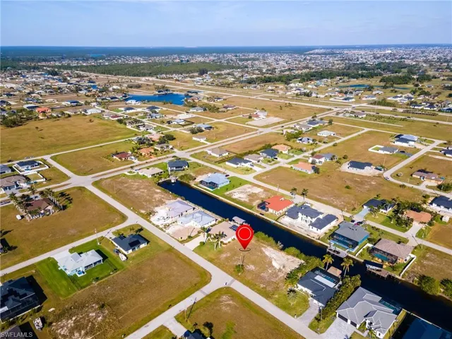 Birds eye view of property featuring a water view and a residential view