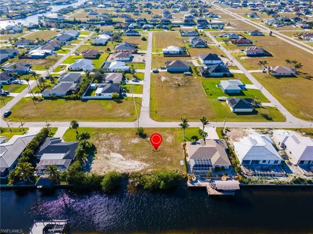 Drone / aerial view with a residential view and a water view