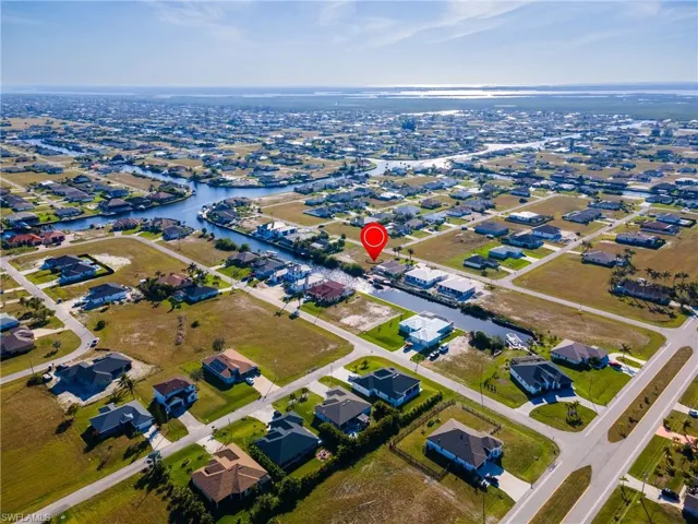 Birds eye view of property featuring a water view and a residential view