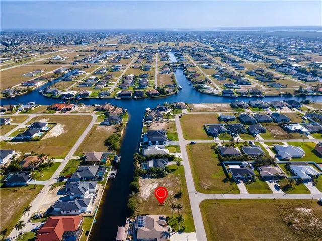 Birds eye view of property featuring a water view and a residential view