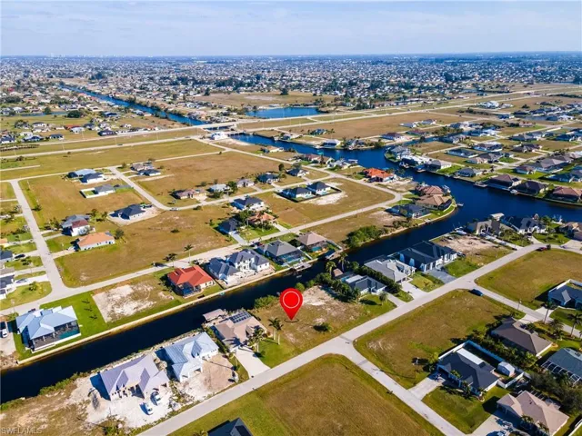 Birds eye view of property featuring a water view and a residential view