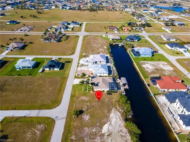 Aerial view featuring a water view and a residential view