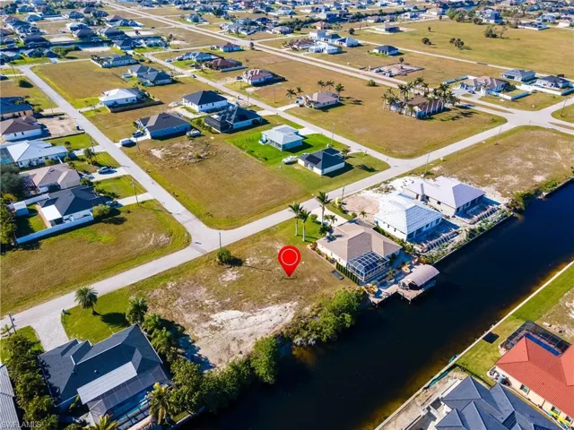 Birds eye view of property featuring a water view and a residential view