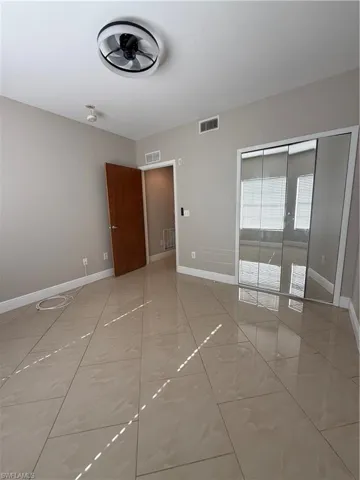 Unfurnished bedroom featuring baseboards and a closet