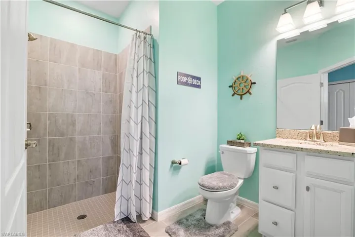 Full bathroom with vanity and a stall shower
