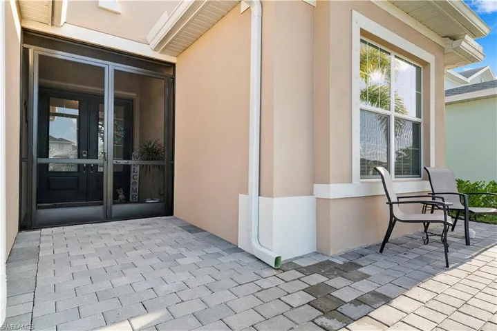 Entrance to property featuring stucco siding and french doors