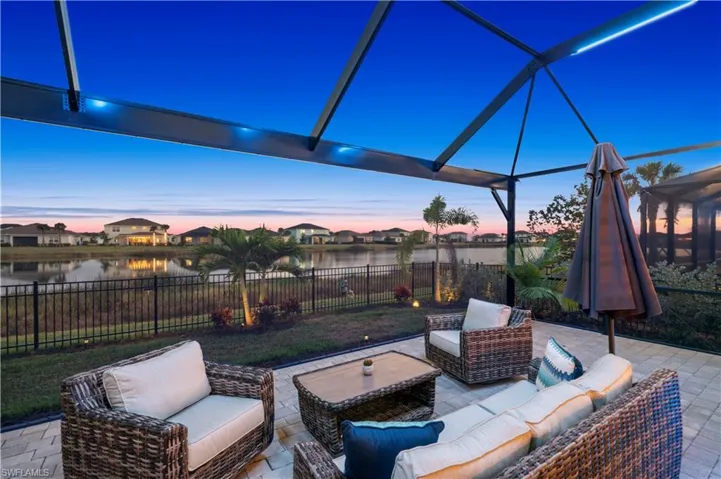 Fenced backyard featuring glass enclosure, an outdoor living space, a patio area, and a sunroom