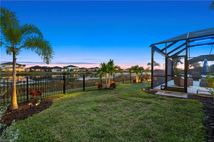 Fenced backyard featuring a lanai, a sunroom, and a residential view