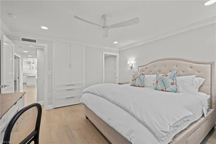 Bedroom with light wood-style flooring, recessed lighting, ornamental molding, and a ceiling fan