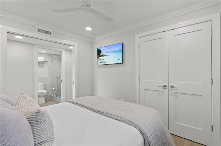Bedroom with crown molding, light wood finished floors, a ceiling fan, a closet, and recessed lighting