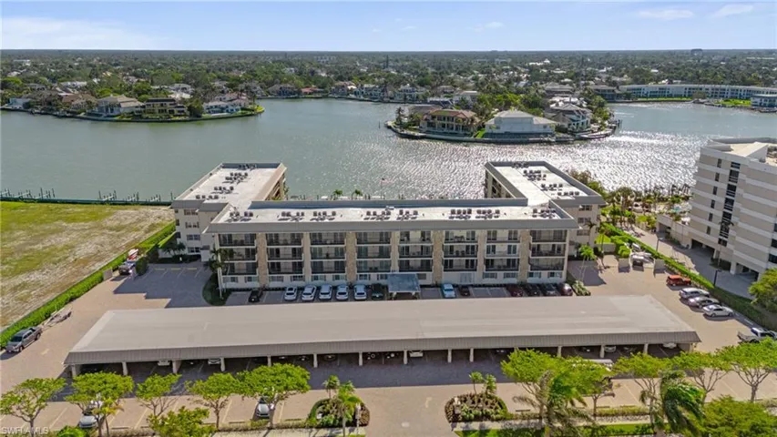 Bird's eye view of a nearby body of water and apartment complex / building
