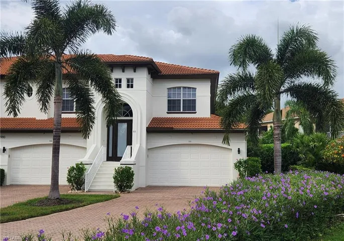 Mediterranean / spanish-style home with a garage