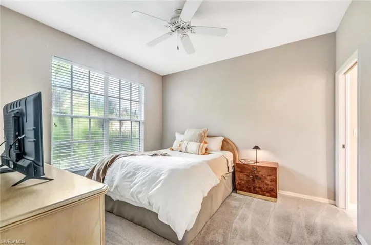 Bedroom featuring ceiling fan and light colored carpet