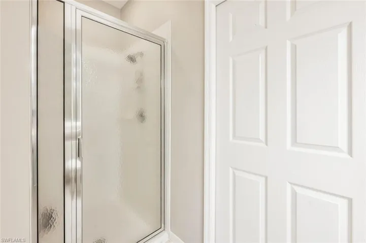 Bathroom with a shower with shower door