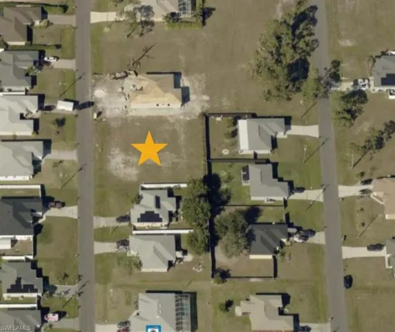 Aerial view of property's location with nearby suburban area