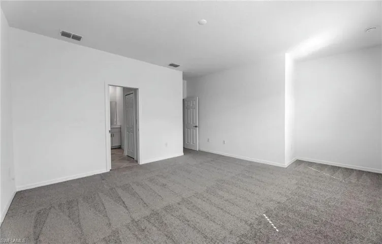 Bright additional bedroom with neutral finishes.