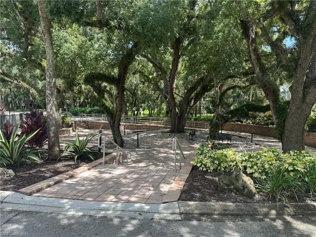 Mature oak trees provide dappled shade throughout this expansive outdoor entertaining space