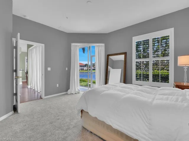 Carpeted bedroom with access to outside