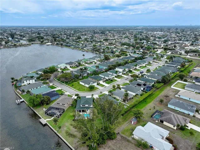 Aerial perspective of suburban area featuring a large body of water