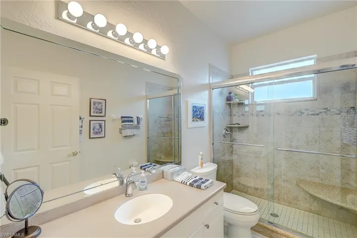 Bathroom with vanity and a stall shower