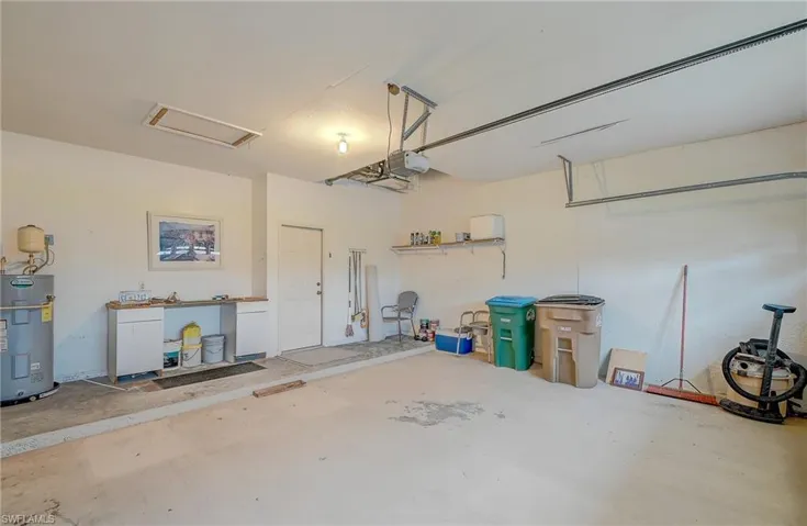 Garage with water heater and a garage door opener