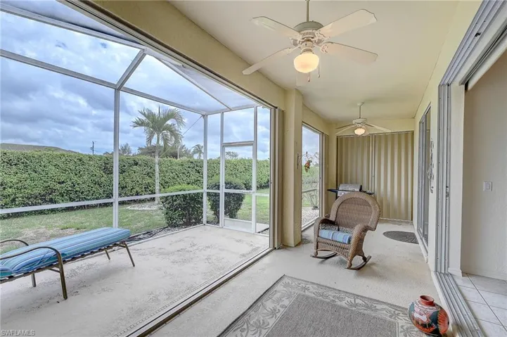 Sunroom featuring a ceiling fan and a patio